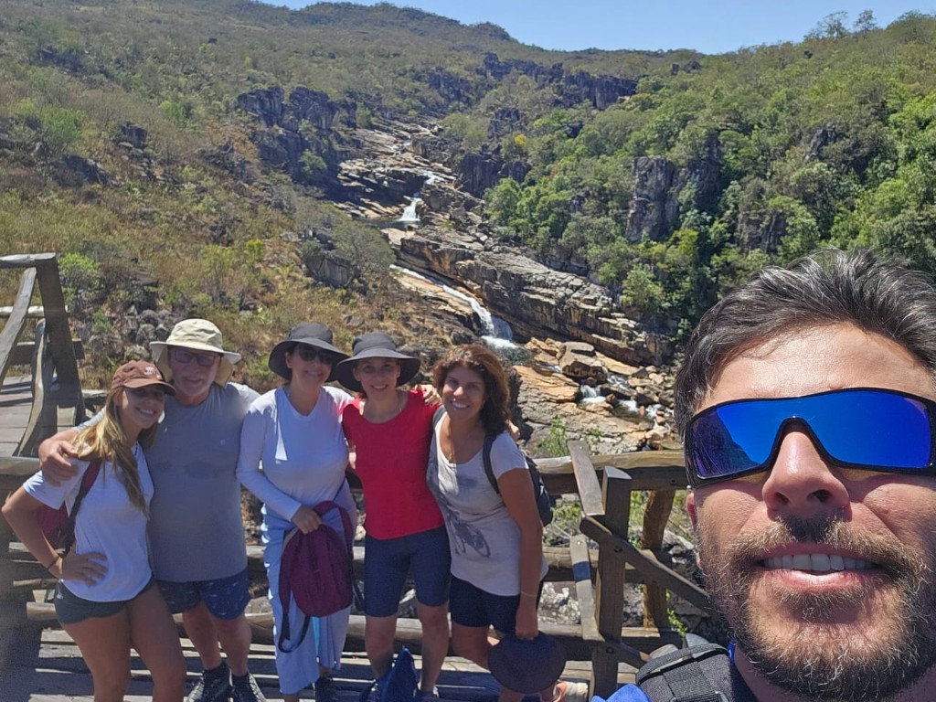 Multi-generational group with guide on a wooden lookout over a canyon and river in Chapada dos Veadeiros